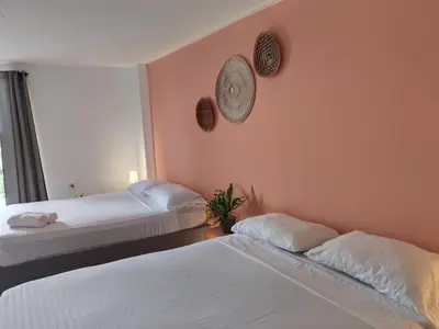 a bedroom with two beds and a wall with two mirrors at Hotel Casa Harmony Cartagena in Cartagena de Indias