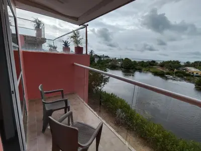 a balcony with two chairs and a view of a river at Hotel Casa Harmony Cartagena in Cartagena de Indias