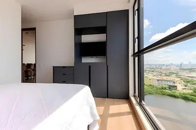 a bedroom with a large window and a tv at Luxury Exlusive Panoramic View & Historic Center in Cartagena de Indias