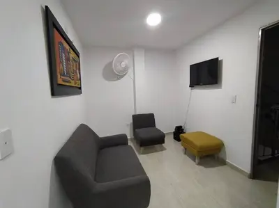 a living room with a couch and a chair at Apto 202, área mtana de Barranquilla in Soledad