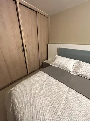 a small room with a bed and cabinets at Apartamento en Alameda Barranquilla in Barranquilla