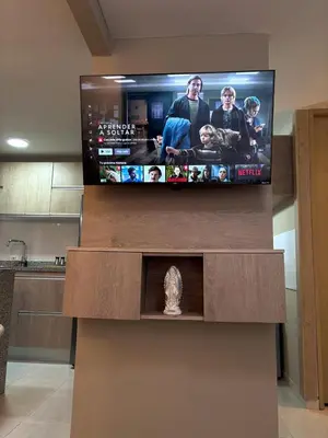 a flat screen tv sitting on top of a entertainment center at Apartamento en Alameda Barranquilla in Barranquilla