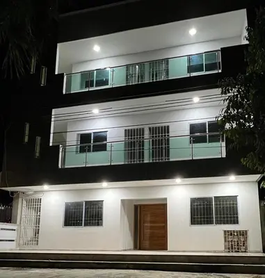a large white building with a balcony on top at Casa Cristal Apto x Dia! in Aracataca