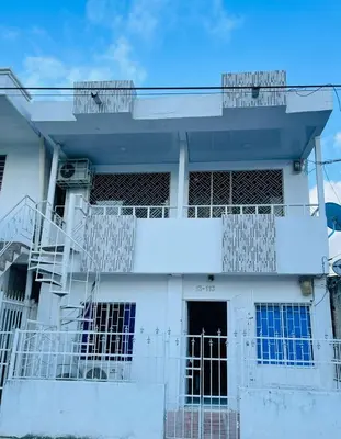 a white building with a staircase in front of it at Apartamento céntrico Torices in Cartagena de Indias