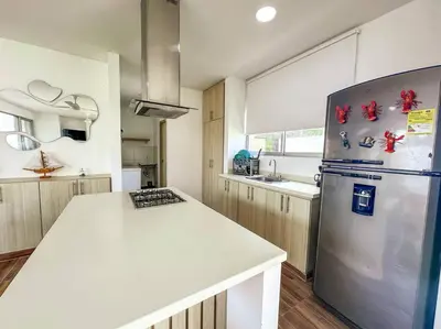 a kitchen with a stainless steel refrigerator and a counter at Casa de Playa ROSANI in Coveñas