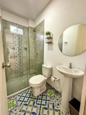 a bathroom with a toilet and a sink and a shower at Casa de Playa ROSANI in Coveñas