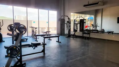 a gym with several tread machines in a room with windows at PLAYA BELLO HORIZONTE 