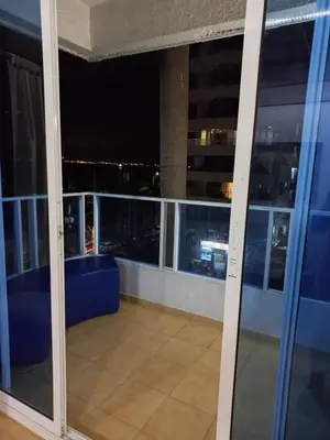 a balcony with a view of the city at night at 1C-AL3E APARTAMENTO DE 1 ALCOBA CERCA AL MAR CON AIRE ACONDICIONADO, PISCINA Y WIFi in Cartagena de Indias