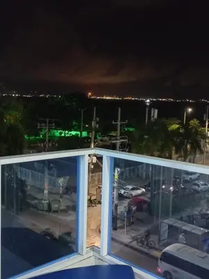 a view of a parking lot at night from a balcony at 1C-AL3E APARTAMENTO DE 1 ALCOBA CERCA AL MAR CON AIRE ACONDICIONADO, PISCINA Y WIFi in Cartagena de Indias