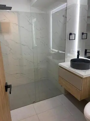 a bathroom with a sink and a glass shower at Apartamento Hotel estelar in Barranquilla
