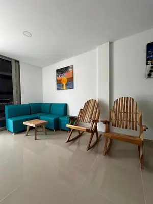 a living room with two chairs and a blue couch at MONTEMAR Casa 2 in Santiago