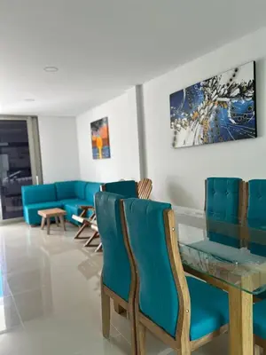 a living room with blue chairs and a table at MONTEMAR Casa 2 in Santiago