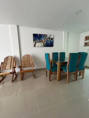 a dining room with chairs and a table and a painting at MONTEMAR Casa 2 in Santiago