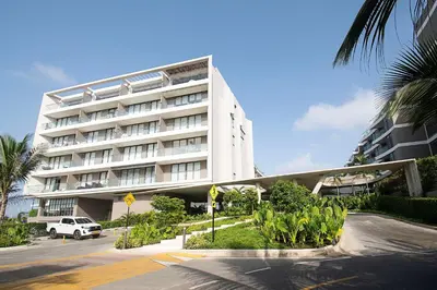 a large white building with a car parked in front of it at U-GO Morros EOS Lujo Frente al Mar en Serena del Mar in Cartagena de Indias