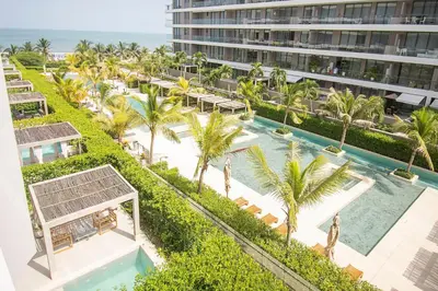 an aerial view of a resort with a pool and palm trees at U-GO Morros EOS Lujo Frente al Mar en Serena del Mar in Cartagena de Indias