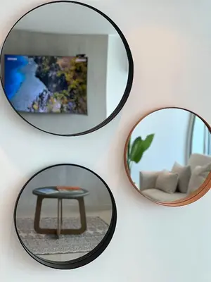 four mirrors on a wall with a table and a couch at Apartment with direct access to the Sea in CTG in Cartagena de Indias