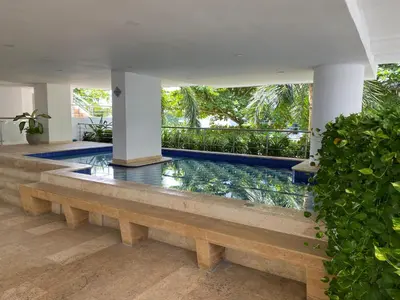 a swimming pool in a villa with a garden at Apartment with direct access to the Sea in CTG in Cartagena de Indias