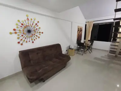 a living room with a brown couch in a room at Apto Marbella in Cartagena de Indias