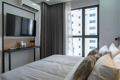 a bedroom with a large bed with a flat screen tv at Luxury Oceanfront Apartment in Cartagena Centro in Cartagena de Indias