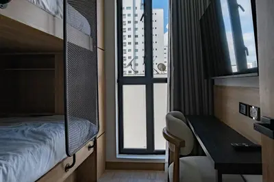 a bedroom with a bed and a desk and a window at Luxury Oceanfront Apartment in Cartagena Centro in Cartagena de Indias