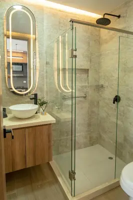 a bathroom with a glass shower and a sink at Luxury Oceanfront Apartment in Cartagena Centro in Cartagena de Indias