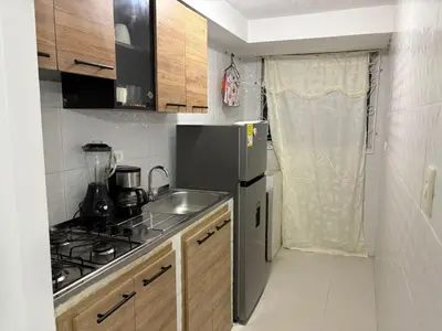 a small kitchen with a sink and a refrigerator at Sol Serena in Soledad