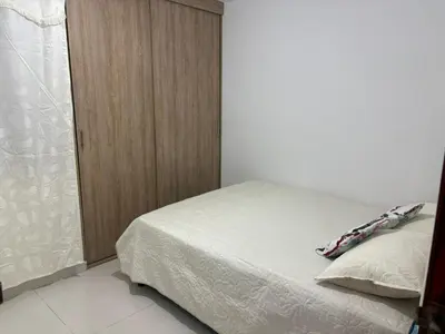 a bedroom with a bed and a wooden cabinet at Sol Serena in Soledad