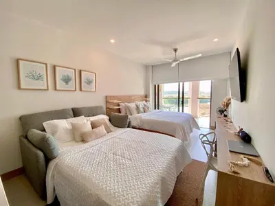 a bedroom with two beds and a couch at Morros EOS Manzanillo piso 3 in Cartagena de Indias