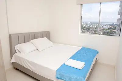 a small bedroom with a bed and a window at Vista panoramica al Mar y Piscina in Cartagena de Indias