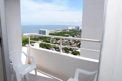a balcony with two chairs and a view of the ocean at Vista panoramica al Mar y Piscina in Cartagena de Indias