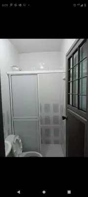a white bathroom with a toilet and a shower at Hotel la Bastilla in Sincelejo