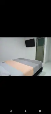 a bedroom with a bed in a room with a window at Hotel la Bastilla in Sincelejo