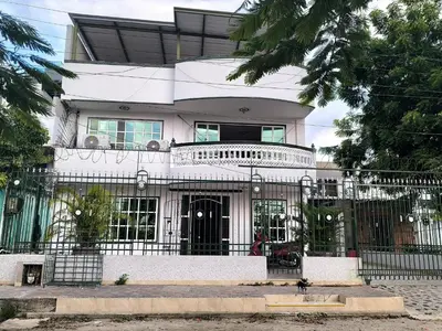 a white house with a fence in front of it at CasaNegreteHostalBoutique in Cartagena de Indias