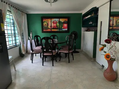 a dining room with green walls and a table and chairs at CasaNegreteHostalBoutique in Cartagena de Indias