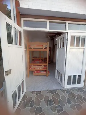 an empty garage with two white doors and a room at Hostal playa descalzo in La Boquilla