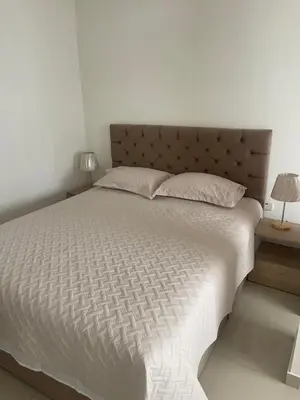 a bedroom with a large bed with white sheets and pillows at Italia boutique #3 in Barranquilla