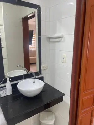 a bathroom with a white sink and a mirror at Italia boutique #3 in Barranquilla