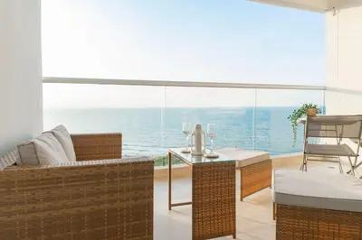 a living room with a view of the ocean at Oceanfront studio + sunset views CB1403 in Cartagena de Indias