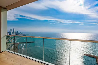 a balcony with a view of the ocean at Dizztravel Apart H2 - 1602 Exclusivo Bocagrande in Cartagena de Indias