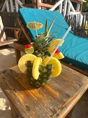 a pineapple arrangement on top of a wooden table at Shekina Club House in Playa Blanca