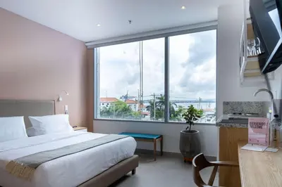 a bedroom with a bed and a large window at San Martin by Wynwood House in Cartagena de Indias