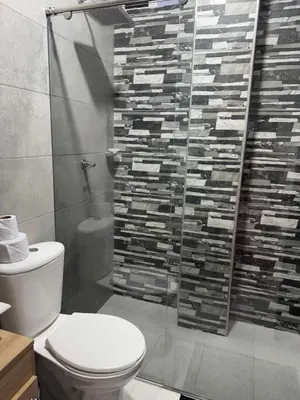 a bathroom with a toilet and a glass shower at Apartamentos el mochilero frente a la playa piso 1 apto 1 in Cartagena de Indias