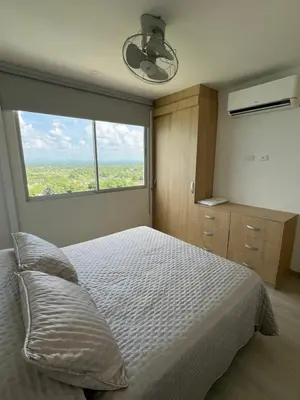 a bedroom with a bed and a large window at Apartamento Torre Vela- Coveñas in Coveñas