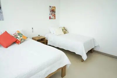 two beds in a room with white walls at Magico Apartamento Frente al Mar 3 Habitaciones PAZ282 in Coveñas