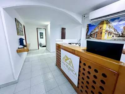 a restaurant with a counter in a room at Hotel CasaBlanca ctg in Cartagena de Indias