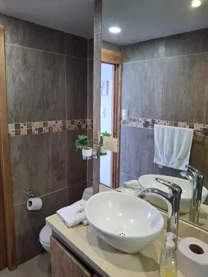 a bathroom with a white sink and a toilet at Apartamento vacacional El Laguito Cartagena in Cartagena de Indias