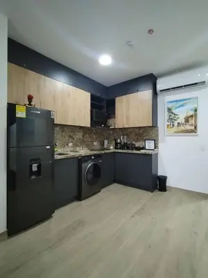 a kitchen with a black refrigerator and a counter at Aparta Suite en Cartagena de Indias in Cartagena de Indias