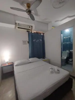 a bedroom with a bed and a ceiling fan at La fantástica Mi Hostal in Cartagena de Indias