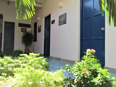 a building with a blue door and some plants at Zana Hotel Boutique in Cartagena de Indias