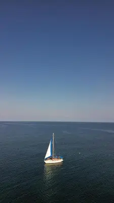 a sailboat in the middle of a large body of water at VelaNova Paradise - HotelRetreat in Isla Fuerte